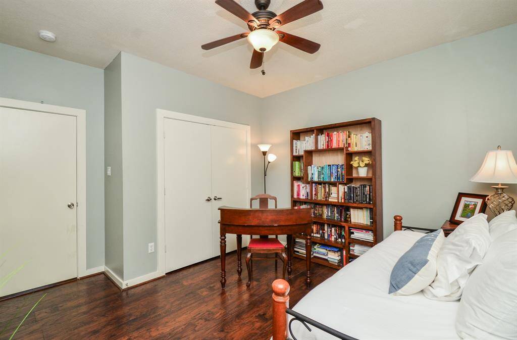 A stepping stone path leads alongside the rear of townhouse, offering easy access to the backyard. The area is well-maintained and inviting, ideal for a cozy outdoor retreat.