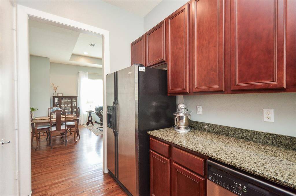 The room is well-lit and has a modern, inviting atmosphere. Large Utility Double Door Closet with amble built-in shortage shelves.