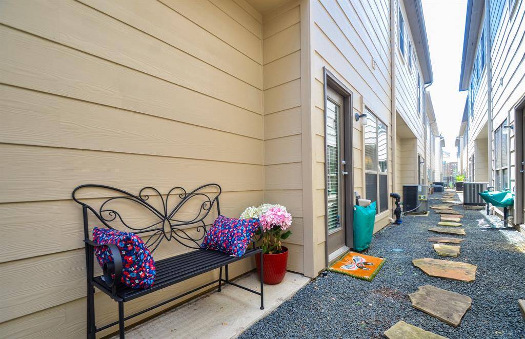 Hardwood stairs leading up to 2nd floor main living area, neutral walls and a hallway with access to extra storage closet, full bathroom, 2nd bedroom, garage door interior entry.