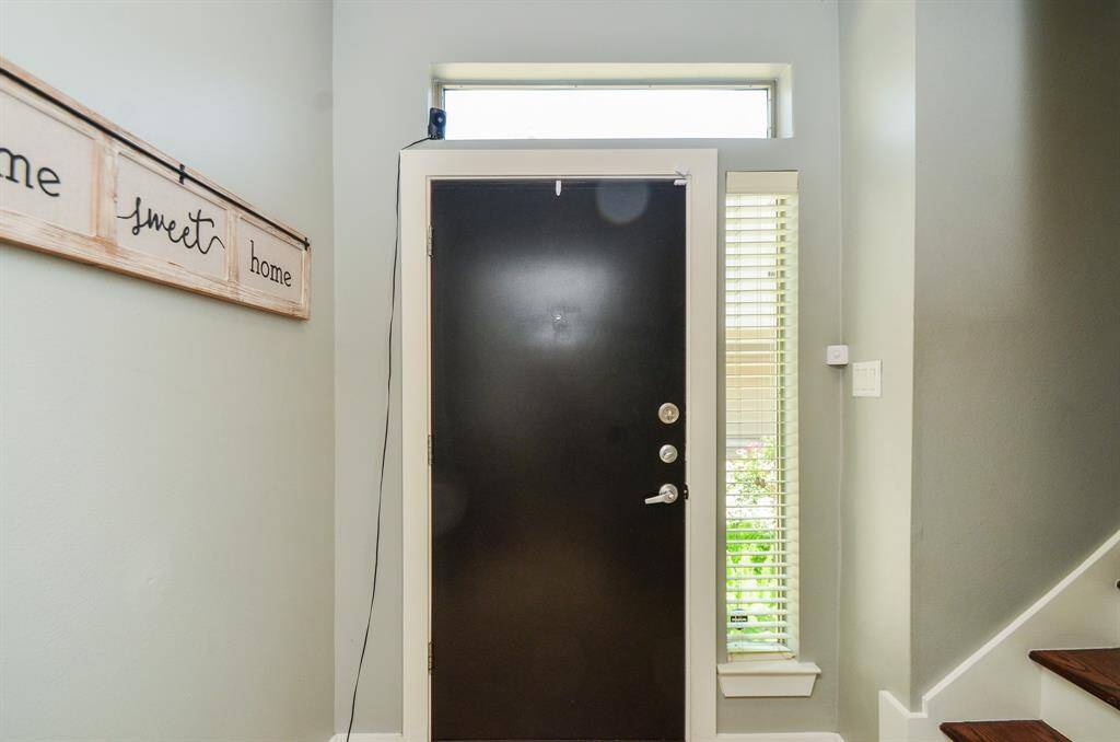 2nd bathroom features a sleek granite countertop with a built-in sink, wooden cabinetry, and a tub-shower combination. A neutral color palette and simple decor add a modern touch.