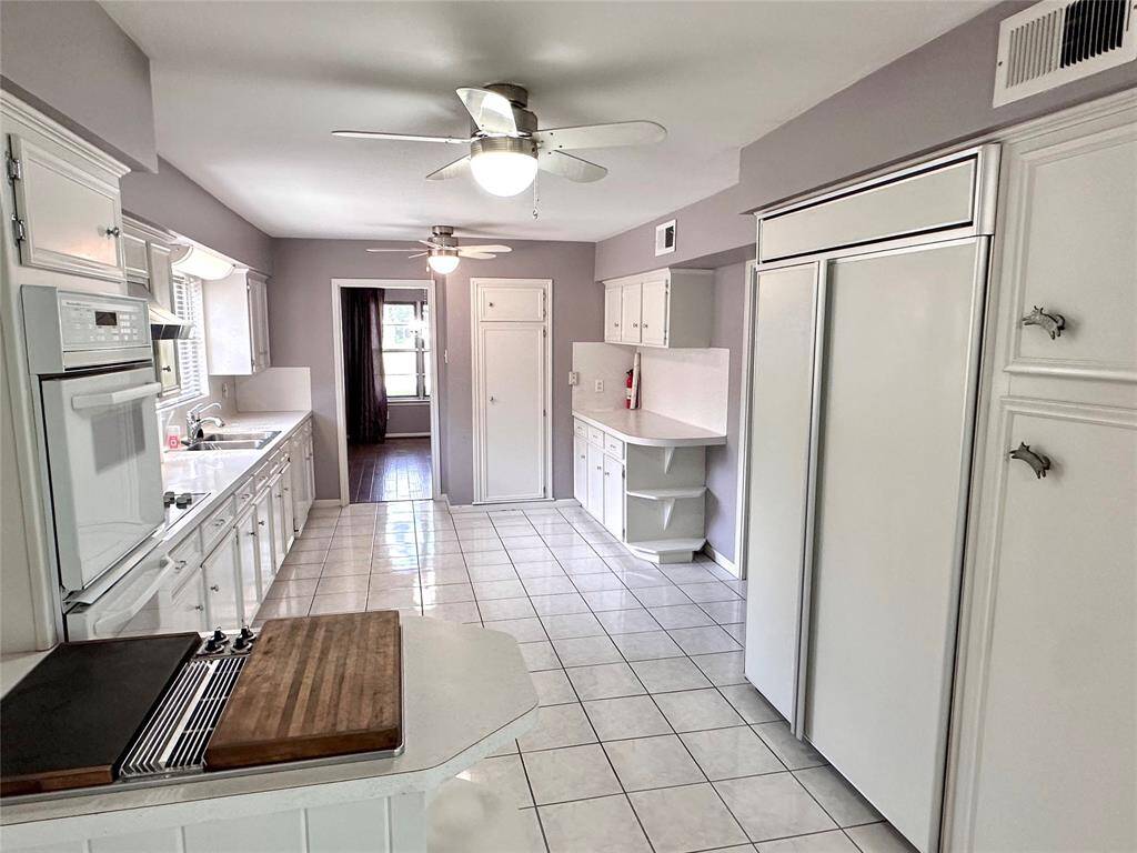 Large commercial size built-in fridge to the right. Lots of cabinet space and counters.