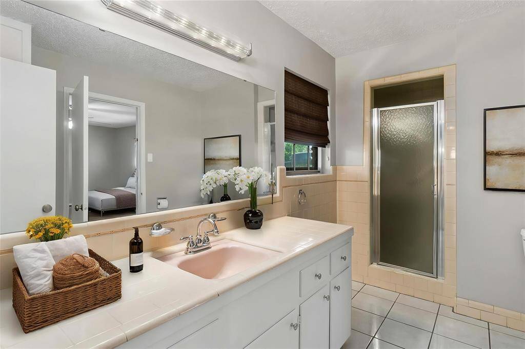 *Virtually Staged* Downstairs Primary bath has lots of counter space, and a standing shower.