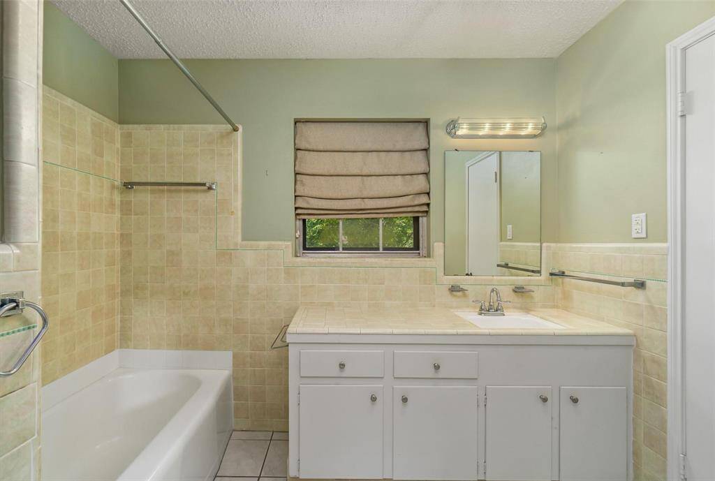 Roomy bath attached to bedroom 2. (Find 2 full baths upstairs.) Large clothing closet to the right, Shower/tub combo.