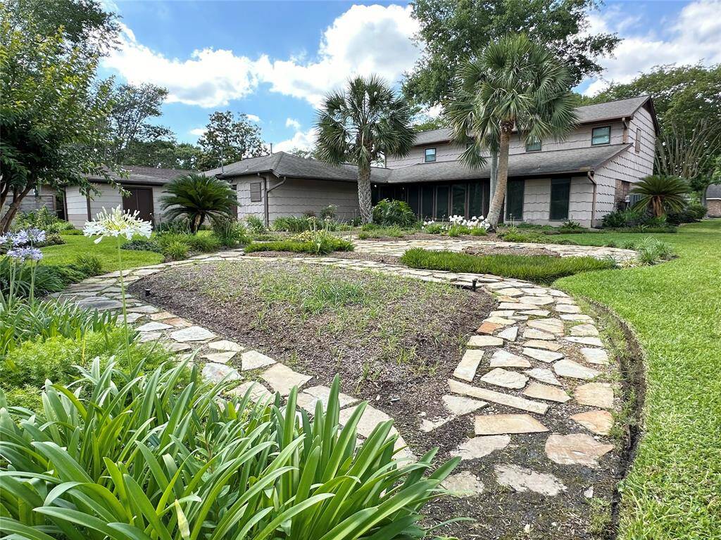 Several walking paths line the back landscaped backyard.