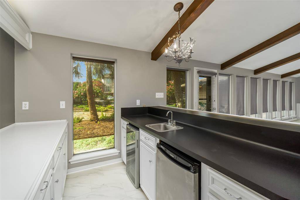 It's 5 o'clock somewhere! Wet bar features sink, lots of counter space, a mini-fridge and a wine fridge with lots of cabinet space for storage.