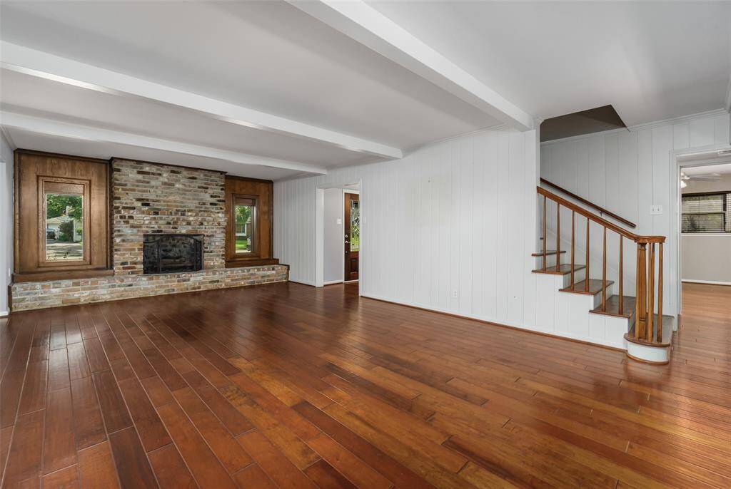 The living room with fireplace is ready to welcome you home! Previously, the seller had a grand piano placed between the front entry and the stairs.