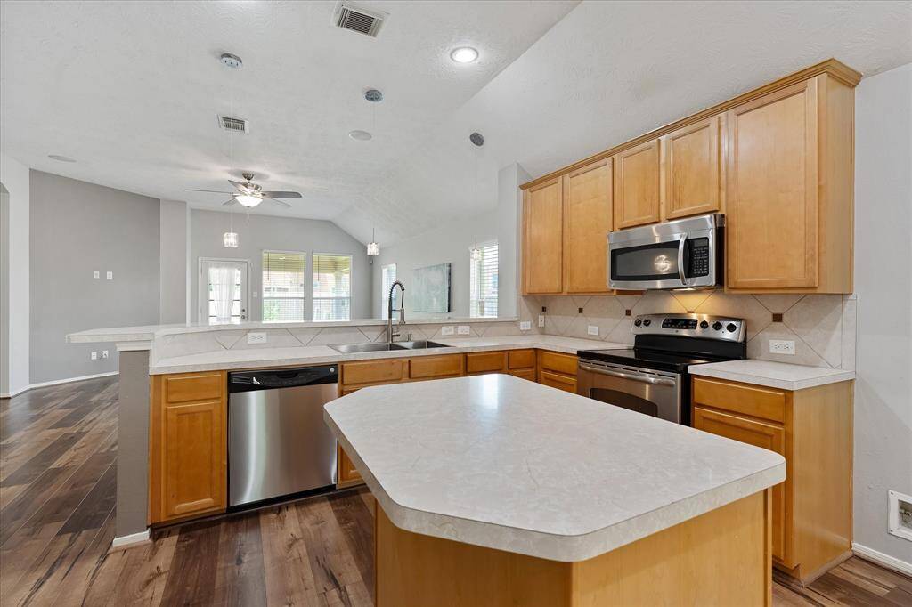 Open concept kitchen with island is handy when making meals.