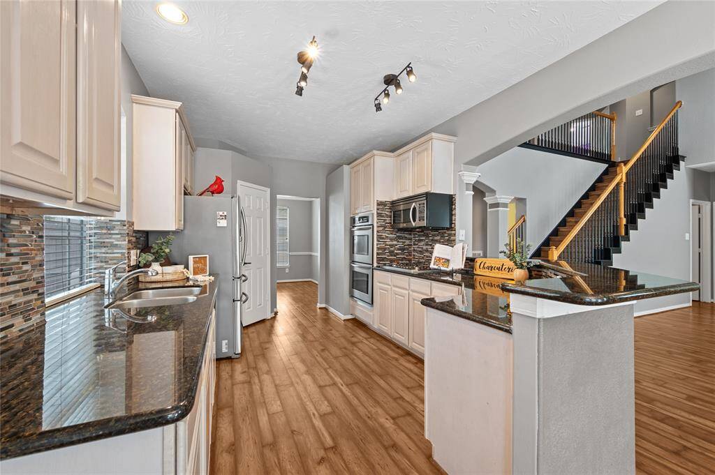 This open floor plan flows so nicely from the family room to the kitchen and even all the way upstairs.