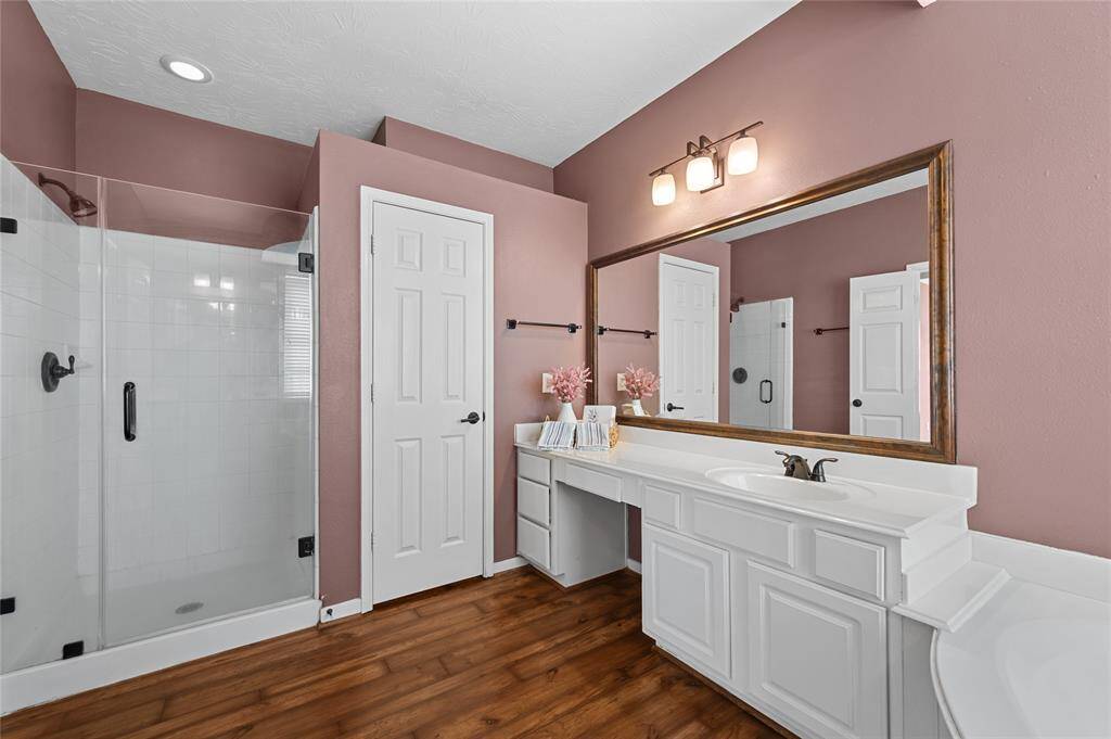 Large primary closet with tons of hanging space and built-in shelving.