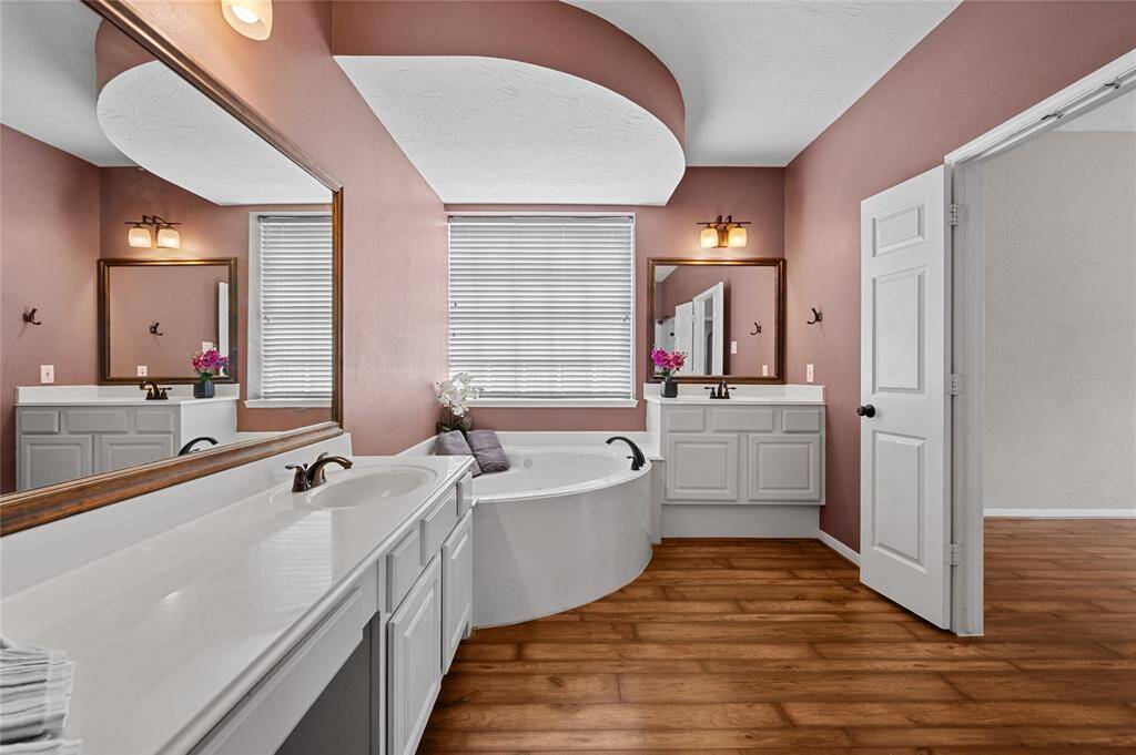 Huge shower in the primary bathroom along with 1 of 2 sinks and functional vanity area.