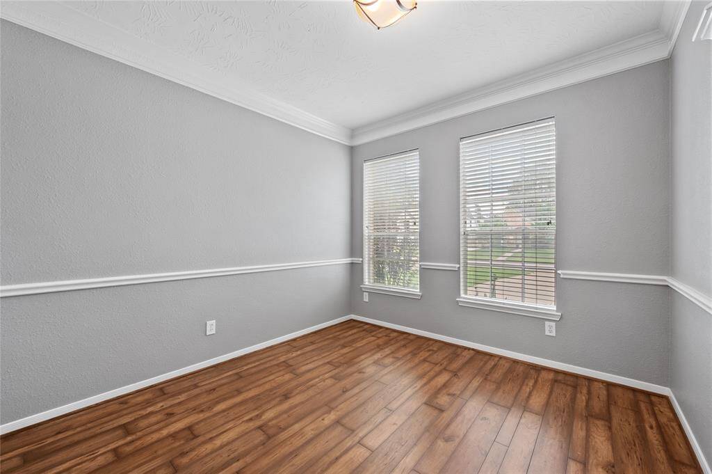 Large, versatile home office faces out towards the front of the home.