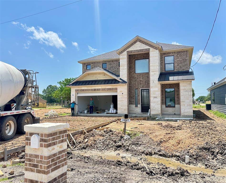 This home features a striking exterior with stone, brick, and lovely metal roof accents. Not to mention, an extra-wide driveway and stunning soffit lights to add to the curb appeal!