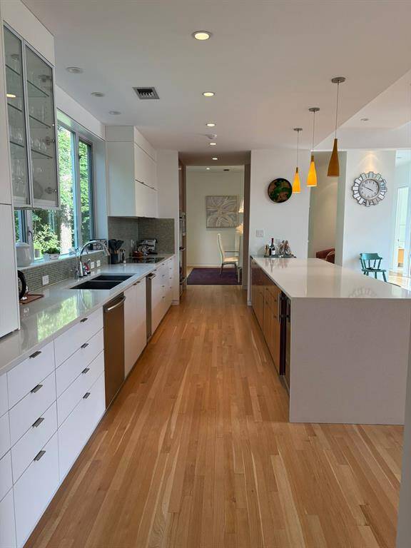 Bright, open kitchen boasts clean lines, luxury finishes, and a layout built for both form and function.