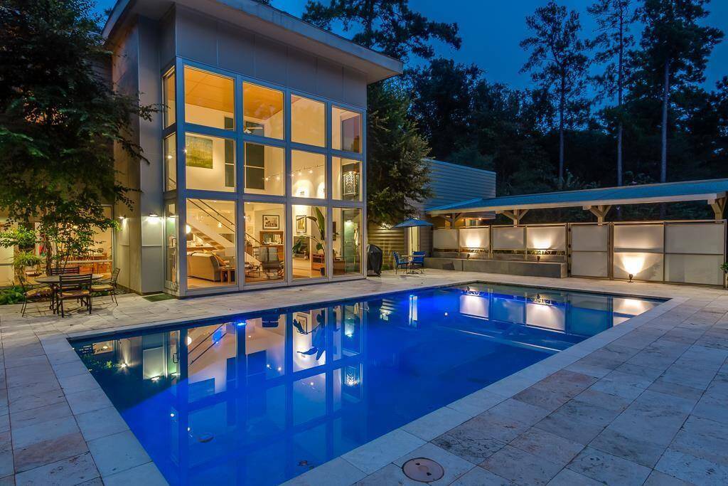 Resort-style pool with elegant lighting and expansive patio perfect for entertaining.