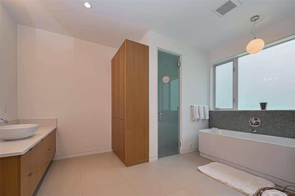 Relax in the freestanding tub surrounded by privacy windows.