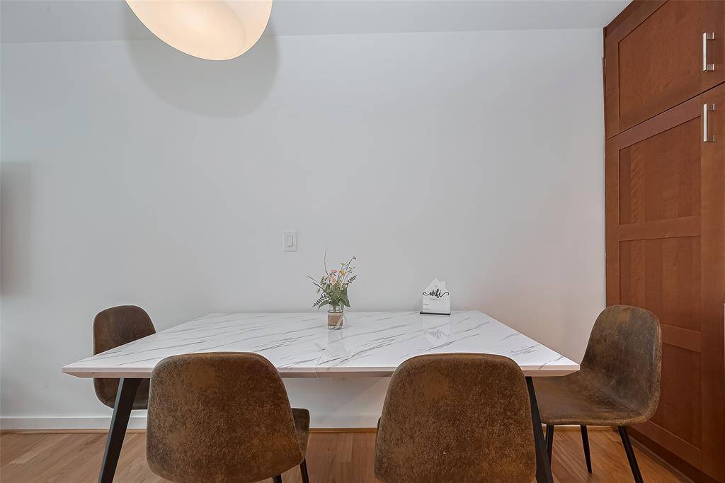 Sleek modern dining table with seating for four and elegant lighting overhead.