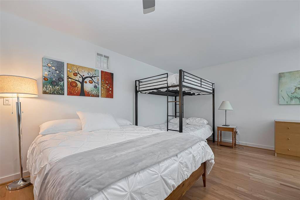 Comfortable sleeping area includes a plush queen bed and sturdy metal bunk beds.