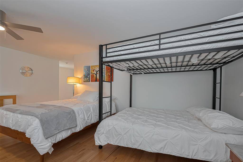 Crisp white linens and clean lines make this bunk bed area perfect for families or guests.
