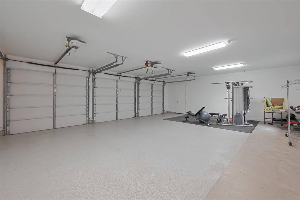 Spacious three-car garage with ample storage space and built-in lighting.