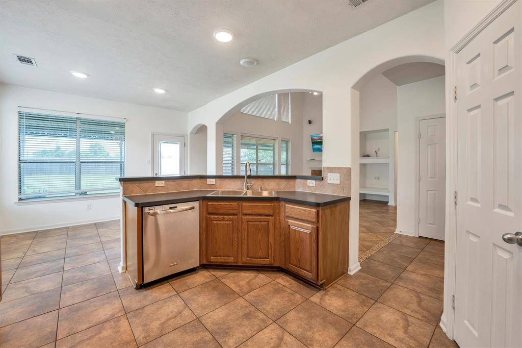 Experience seamless living in this open-concept space, where the kitchen flows into the breakfast area and a spacious vaulted living room.