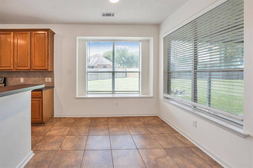 Experience serene mornings or relaxed dinners in this inviting eat-in area by the kitchen.