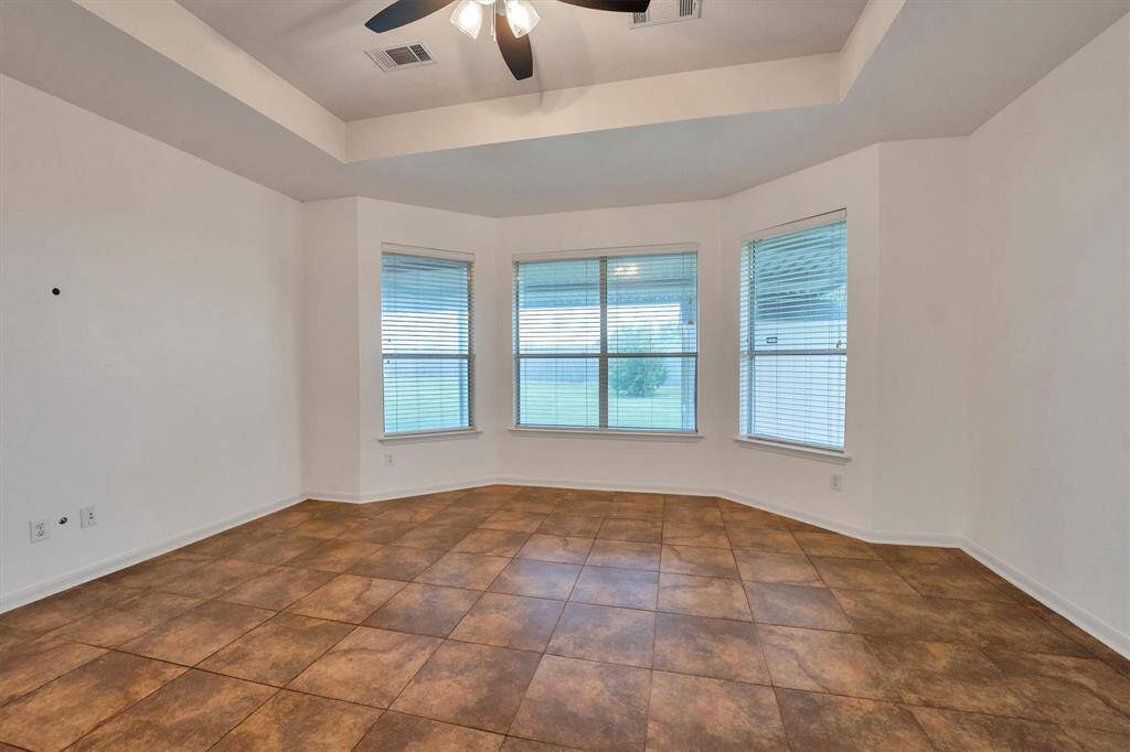 Relax in your tranquil primary suite, featuring tray ceilings and large windows overlooking your backyard oasis.