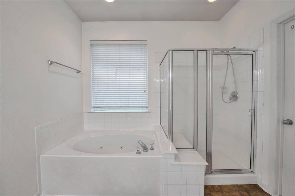 Indulge in relaxation with a luxurious soaking tub and a modern standalone shower.