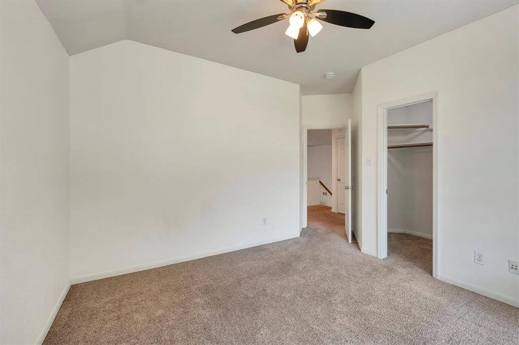 Another view of the upstairs third bedroom with a walk-in closet