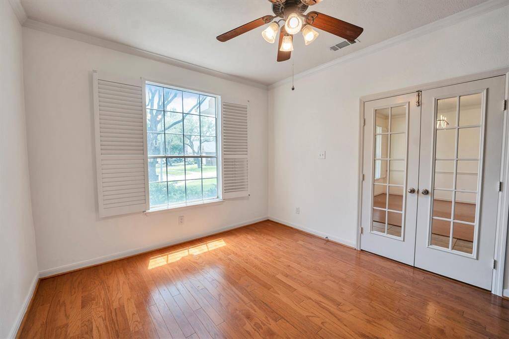 Just off the entry, a spacious office or flex space awaits - featuring plantation shutters, double entry doors, and a built-in shelving.