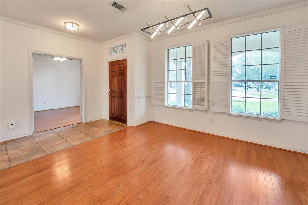 Bright, spacious dining room with abundant natural light near the entrance.