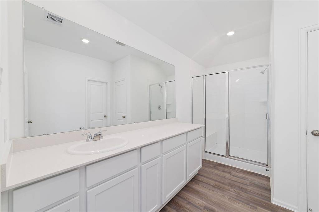 Ensuite bath features an oversized shower with a shower bench, and a large walk-in closet.