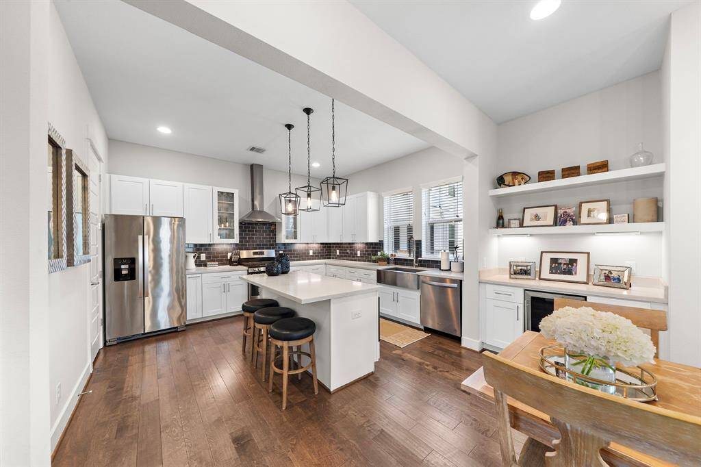 Modern kitchen featuring quartz counters and a dry-bar.