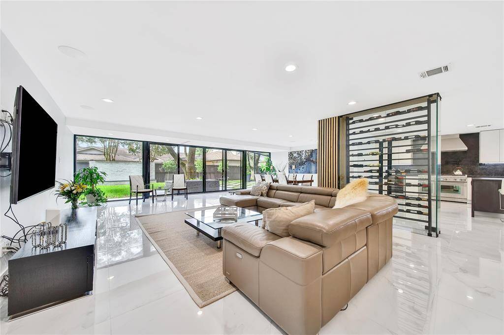 Spacious family room featuring wine cellar and backyard views.