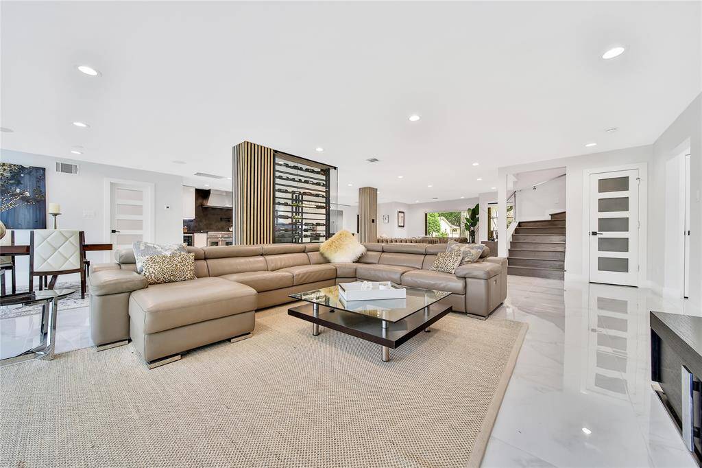 Spacious family room featuring wine cellar and backyard views.