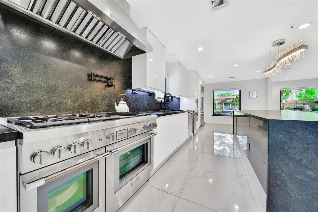The kitchen features premium Thermador appliances, built in coffee maker, ice maker, soft close cabinets and drawers, pot filler, whole house water softener system, and more!