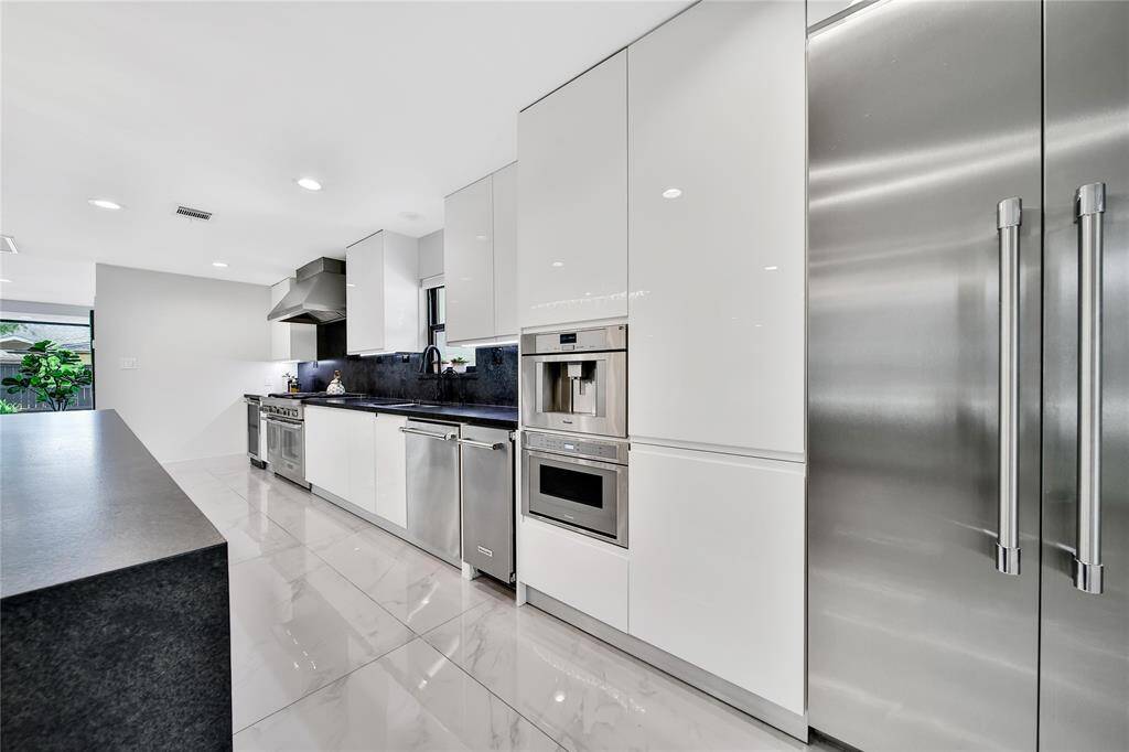 The kitchen features premium Thermador appliances, built in coffee maker, ice maker, soft close cabinets and drawers, pot filler, whole house water softener system, and more!