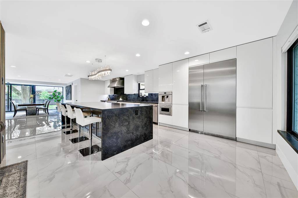 The kitchen features premium Thermador appliances, built in coffee maker, ice maker, soft close cabinets and drawers, pot filler, whole house water softener system, and more!