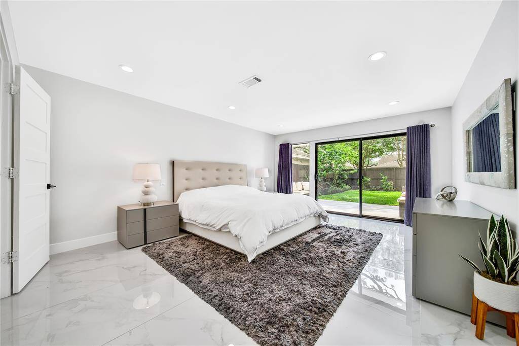 Expansive primary suite with ensuite bathroom and patio access.