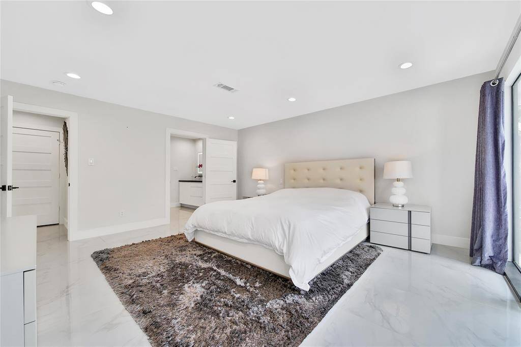 Expansive primary suite with ensuite bathroom and patio access.