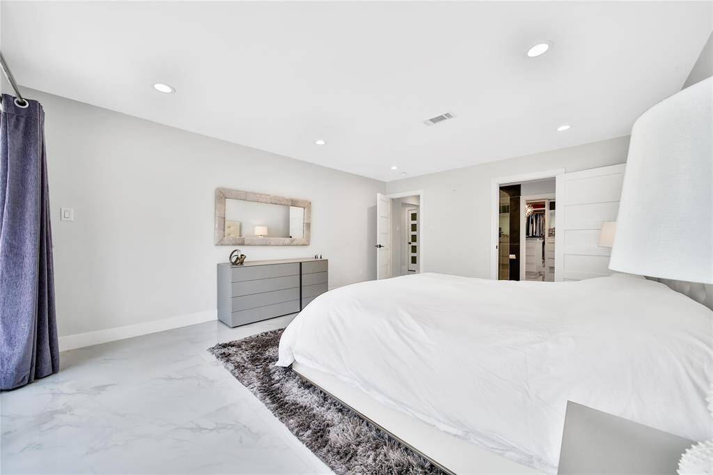 Expansive primary suite with ensuite bathroom and patio access.