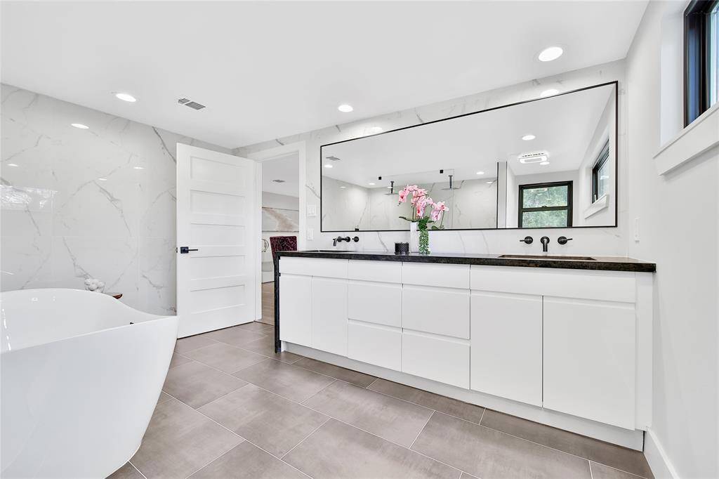 Beautiful upstairs primary bathroom with double sinks, soaking tub, glass shower with dual shower heads.