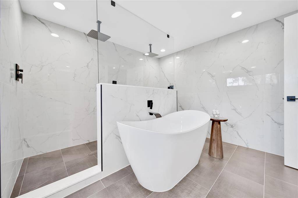Beautiful upstairs primary bathroom with double sinks, soaking tub, glass shower with dual shower heads.