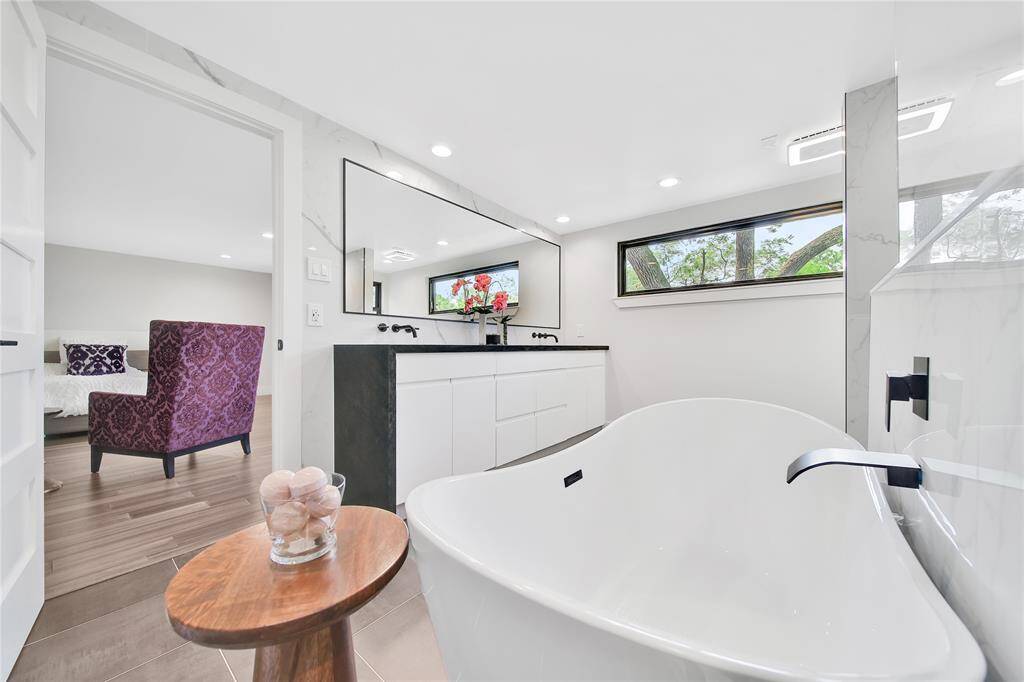 Beautiful upstairs primary bathroom with double sinks, soaking tub, glass shower with dual shower heads.
