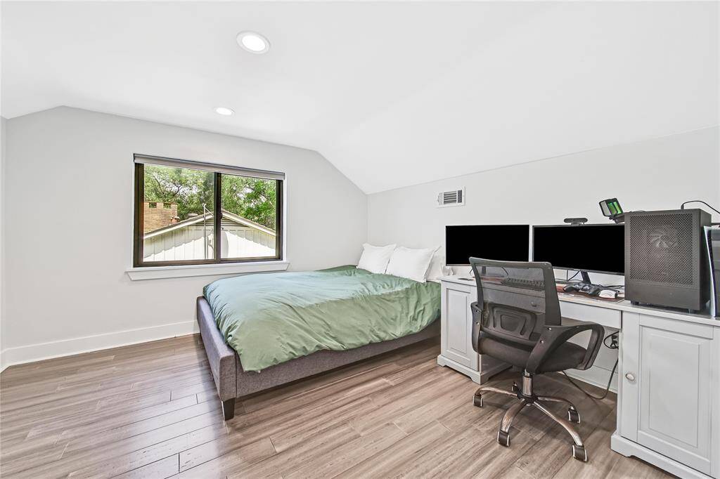 Upstairs secondary bedroom with spacious walk-in closet.
