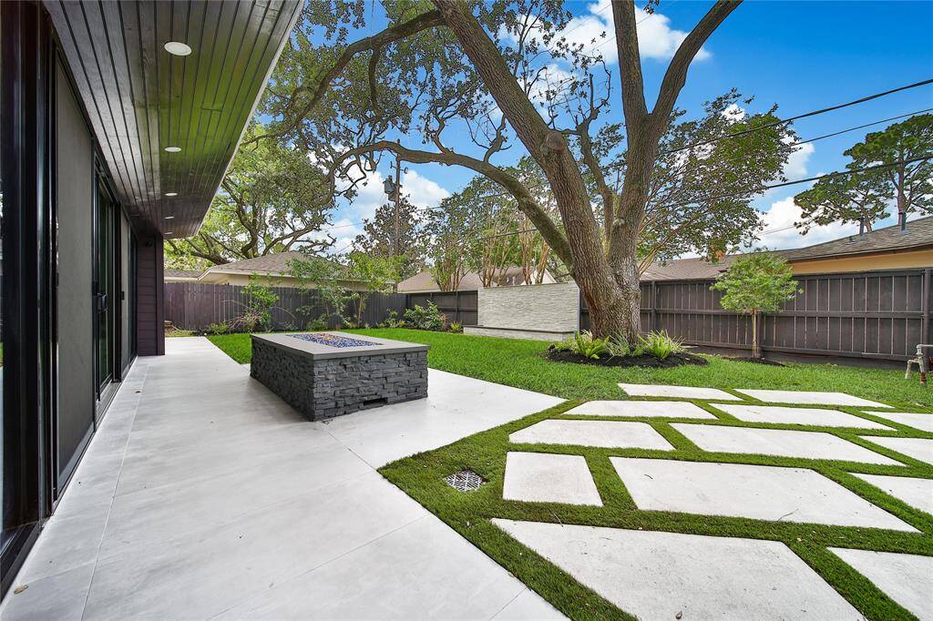 Beautiful backyard upgrades include fire pit, water features, outdoor kitchen, and more!