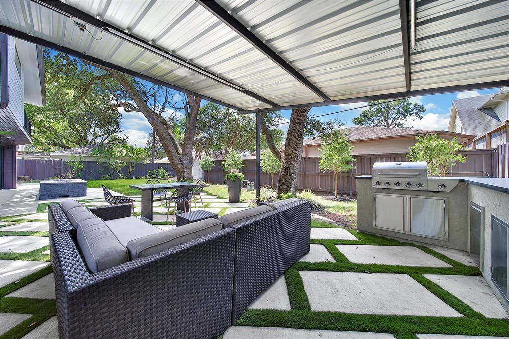 Beautiful backyard upgrades include fire pit, water features, outdoor kitchen, and more!