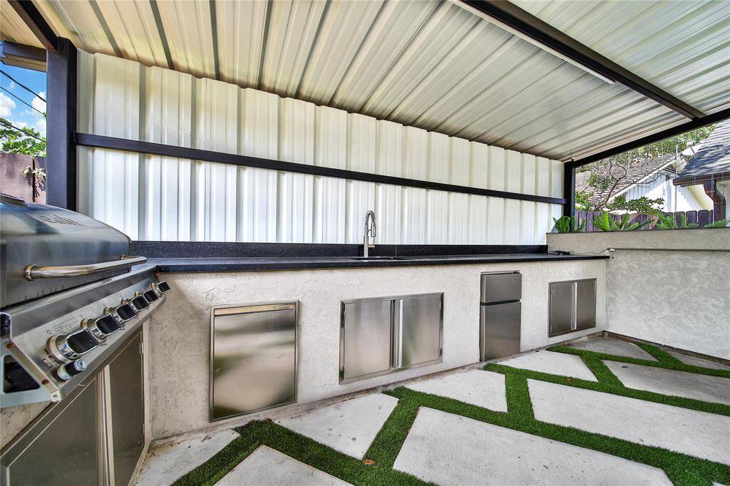 Beautiful backyard upgrades include fire pit, water features, outdoor kitchen, and more!