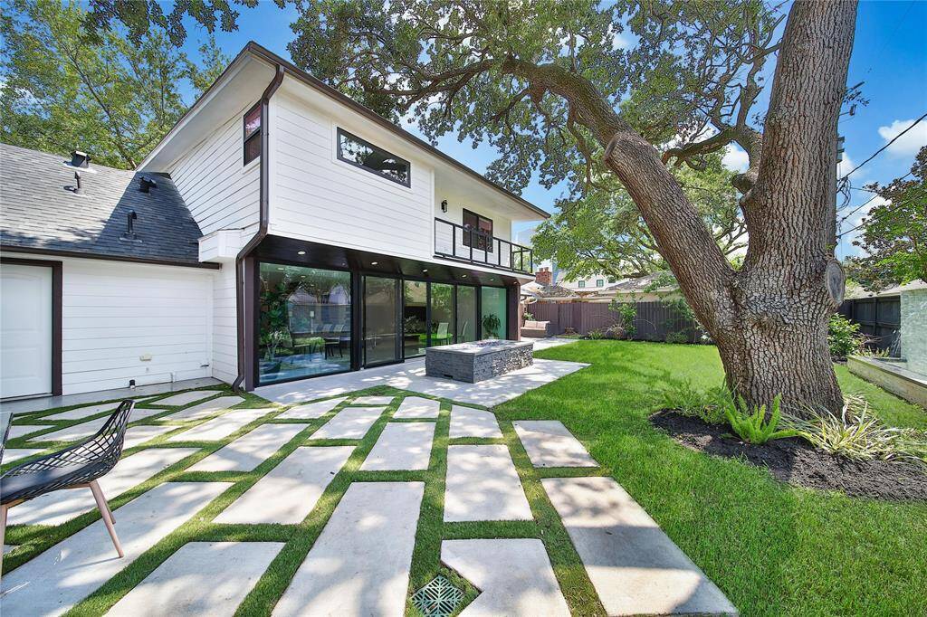 Beautiful backyard upgrades include fire pit, water features, outdoor kitchen, and more!