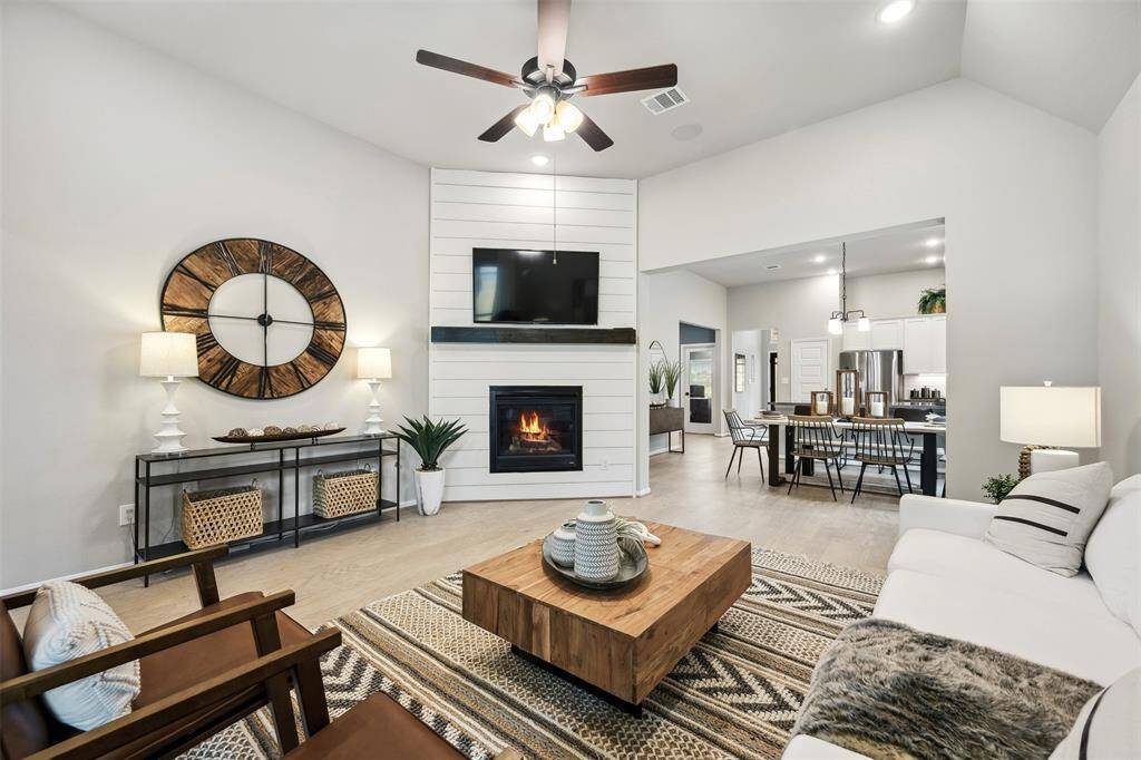 Gather and relax in the great room, anchored by a cozy fireplace with shiplap accent