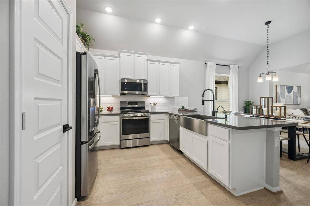 Stylish kitchen with quartz countertops and stainless appliances